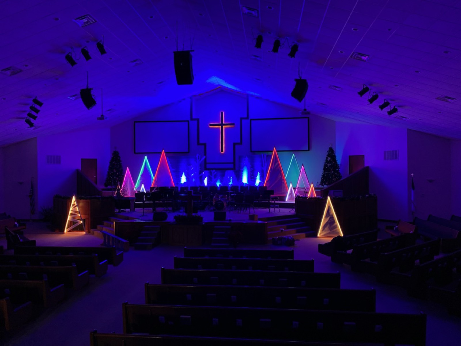 Sanctuary washed in blue stage lighting with lit crosses at Sharon Baptist Church, Tecumseh, Oklahoma